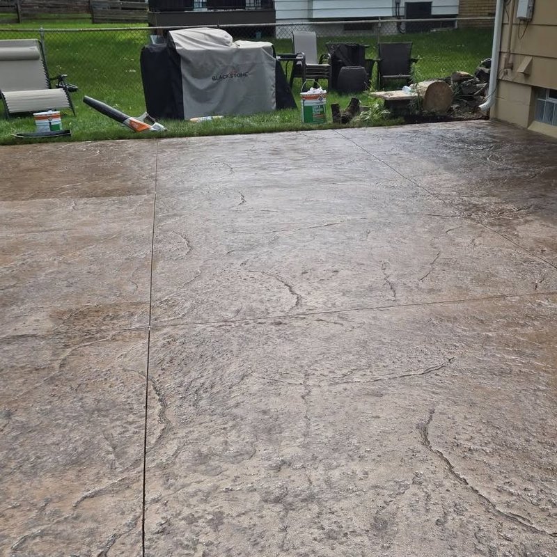 Stamped concrete patio with grill staged along the edge