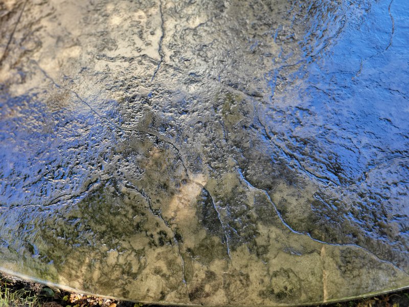 Close-up of textured, mottled stamped concrete surface in blue-gray tones