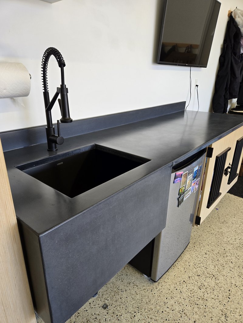Black concrete kitchenette countertop with an undermount sink