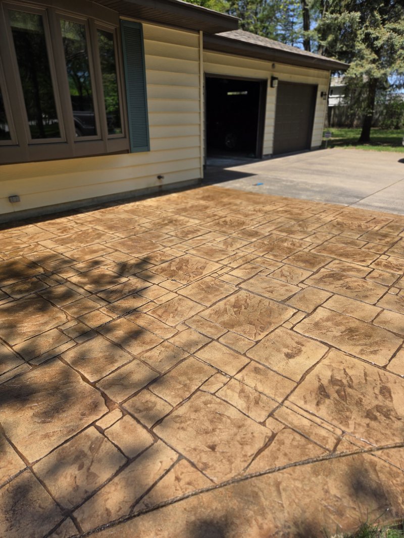 Stamped concrete driveway with tan ashlar-pattern coloring